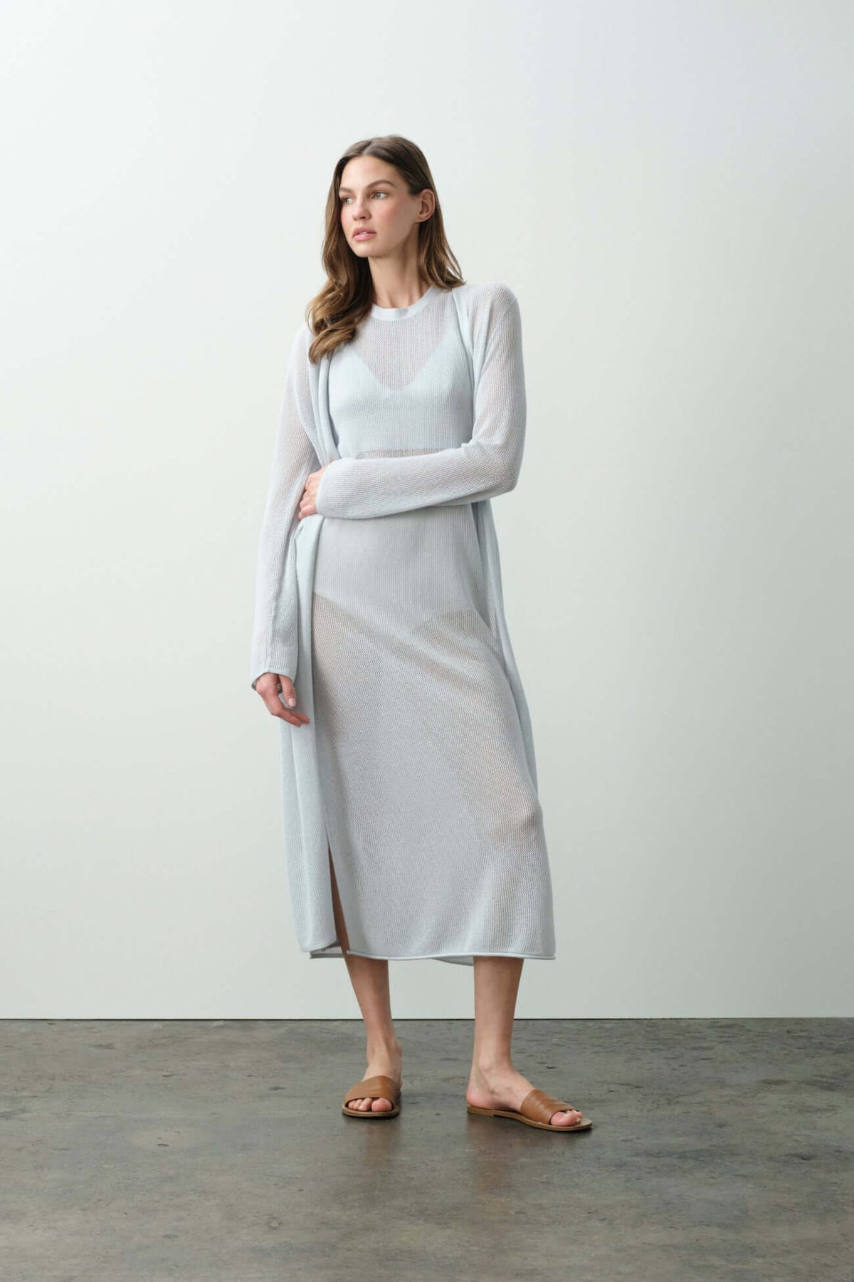 Model wearing a light blue cardigan with a long dress, showcasing the elegance of Cardigans in fashion.